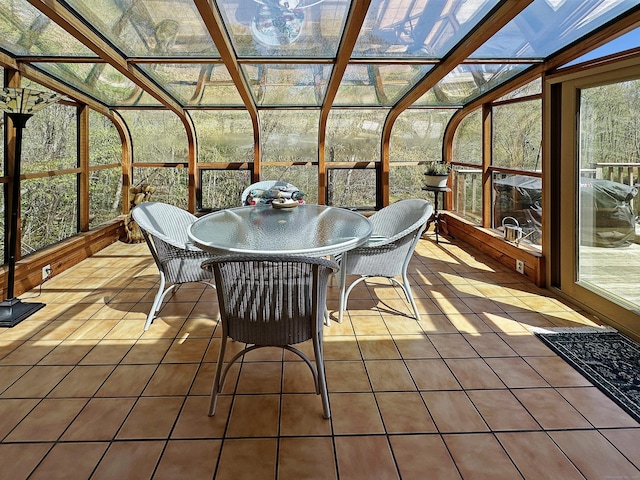 sunroom featuring outdoor dining space