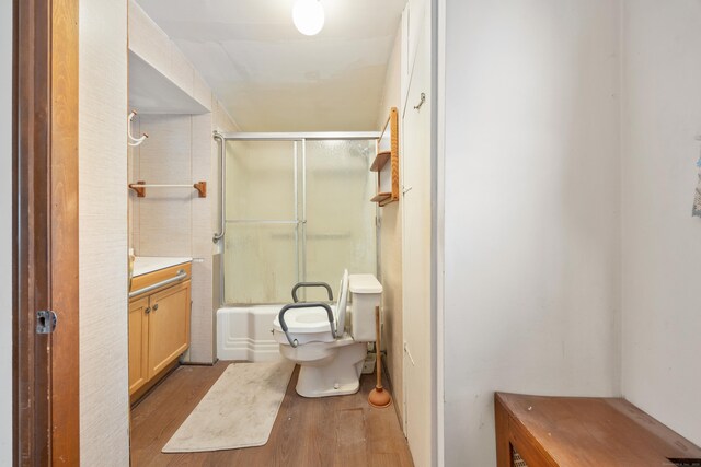 170 Park Rd, Waterbury, CT 06708 - bathroom featuring bath / shower combo with glass door, wood finished floors, toilet, and vanity