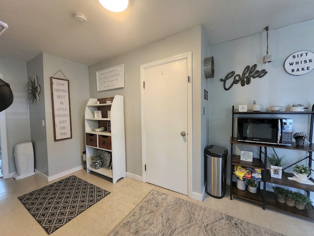 interior space with baseboards and wood finished floors