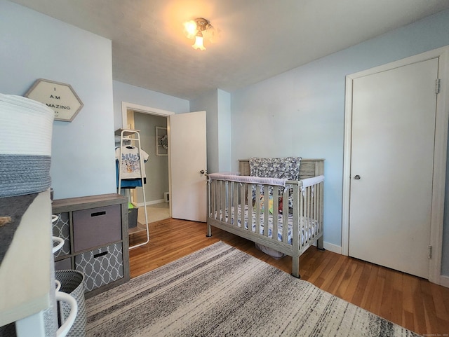 bedroom with baseboards and wood finished floors