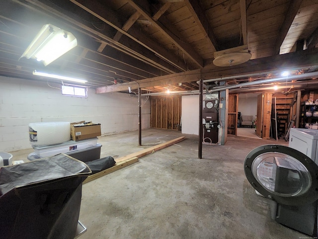below grade area with washer / clothes dryer and heating unit