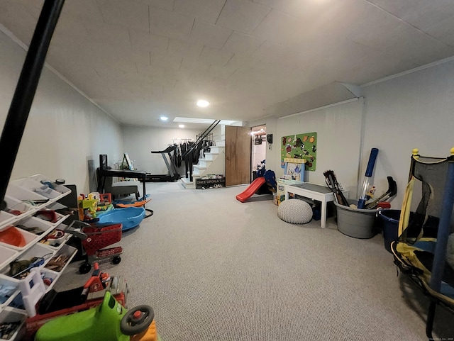 exercise area with crown molding and carpet