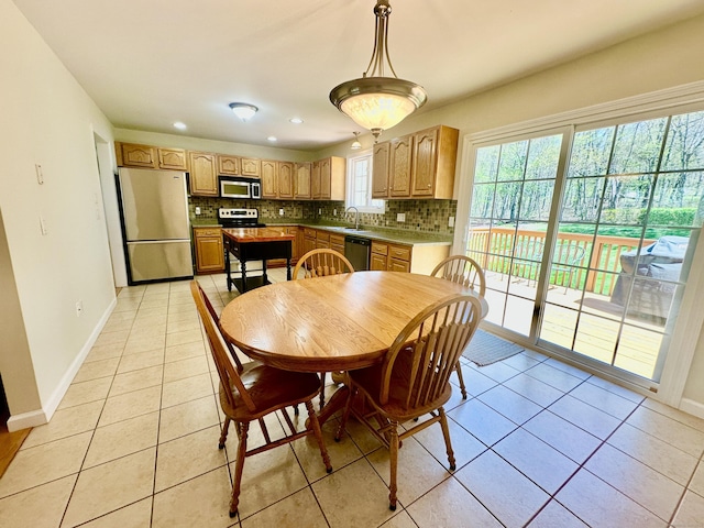 dining area featuring recessed lighting, baseboards, and light tile patterned floors