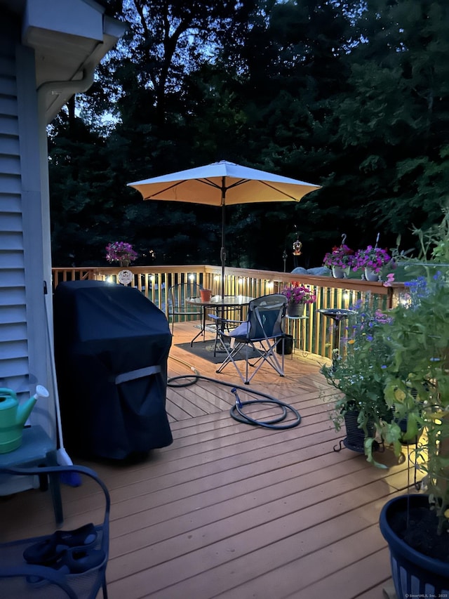 deck at twilight featuring grilling area
