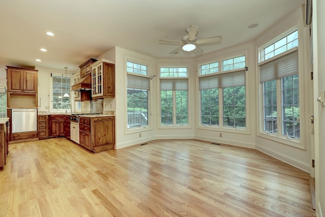 395 Isinglass Rd, Shelton, CT 06484 - kitchen featuring brown cabinets, appliances with stainless steel finishes, plenty of natural light, light wood finished floors, and recessed lighting
