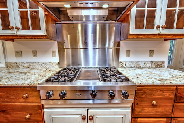 395 Isinglass Rd, Shelton, CT 06484 - kitchen featuring glass insert cabinets, stainless steel stovetop, and light stone countertops