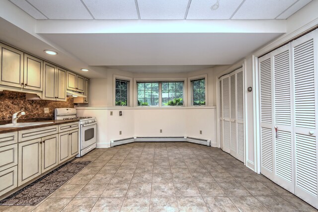 395 Isinglass Rd, Shelton, CT 06484 - kitchen with white gas range oven, a sink, under cabinet range hood, a baseboard radiator, and tasteful backsplash