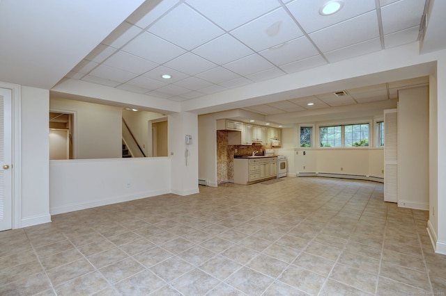 395 Isinglass Rd, Shelton, CT 06484 - unfurnished living room with baseboard heating, recessed lighting, stairs, a drop ceiling, and light tile patterned flooring