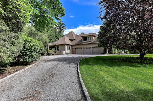 395 Isinglass Rd, Shelton, CT 06484 - view of front of house featuring gravel driveway, a front yard, and a garage