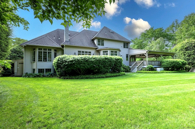 395 Isinglass Rd, Shelton, CT 06484 - rear view of house with a chimney, a yard, and a shingled roof