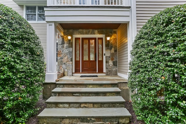 doorway to property featuring stone siding