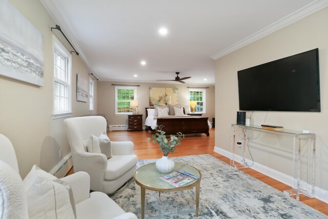 living area featuring ceiling fan, a baseboard heating unit, baseboards, recessed lighting, and light wood finished floors