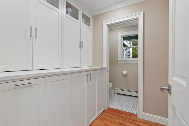 mudroom with baseboard heating, baseboards, light wood-type flooring, and crown molding
