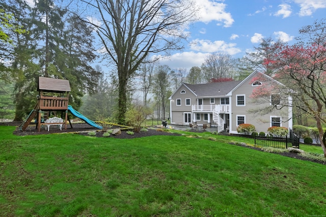 view of yard with fence and a playground