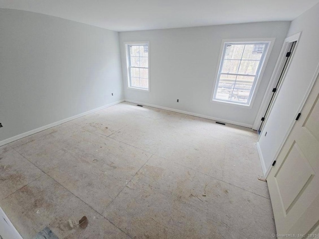 empty room with visible vents and baseboards