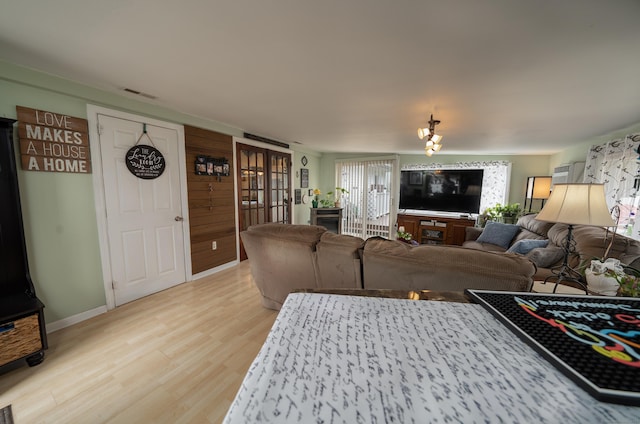living area featuring visible vents and light wood-type flooring