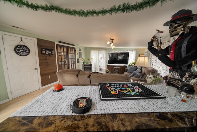 living area with visible vents and wood finished floors