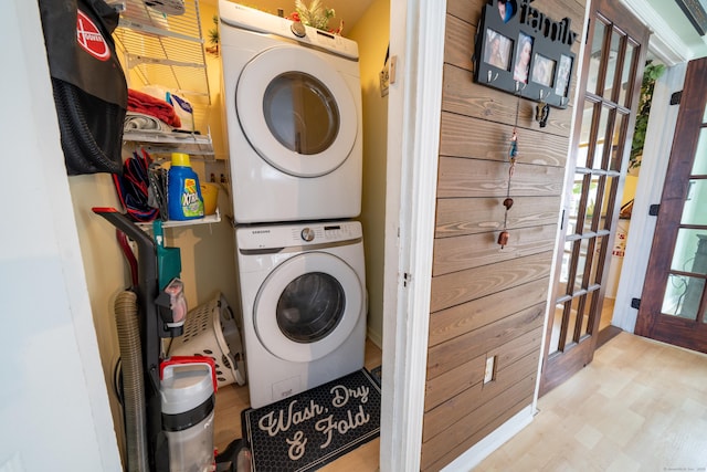 laundry room with stacked washer and dryer and laundry area