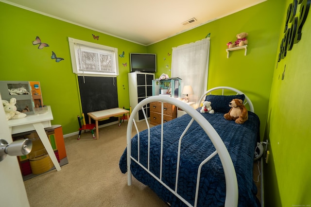 carpeted bedroom featuring visible vents and ornamental molding
