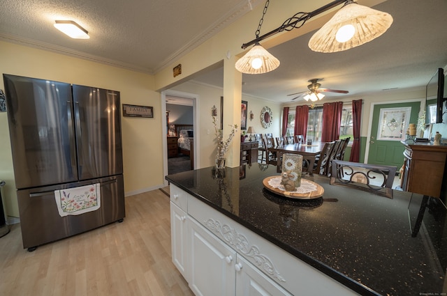 kitchen with light wood-style floors, ceiling fan, crown molding, white cabinets, and freestanding refrigerator