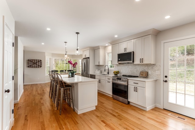 19 Stony Brook Rd, Brookfield, CT 06804 - kitchen featuring a sink, light wood-type flooring, visible vents, a kitchen island, and appliances with stainless steel finishes