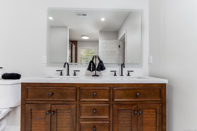 19 Stony Brook Rd, Brookfield, CT 06804 - bathroom featuring double vanity, visible vents, toilet, and a sink