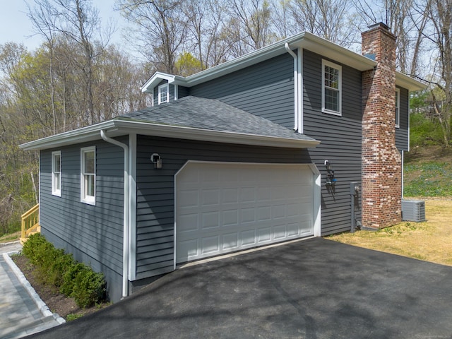 19 Stony Brook Rd, Brookfield, CT 06804 - view of side of home featuring a chimney, central air condition unit, a garage, driveway, and roof with shingles
