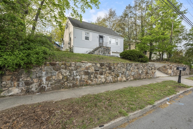 view of front of property featuring roof with shingles