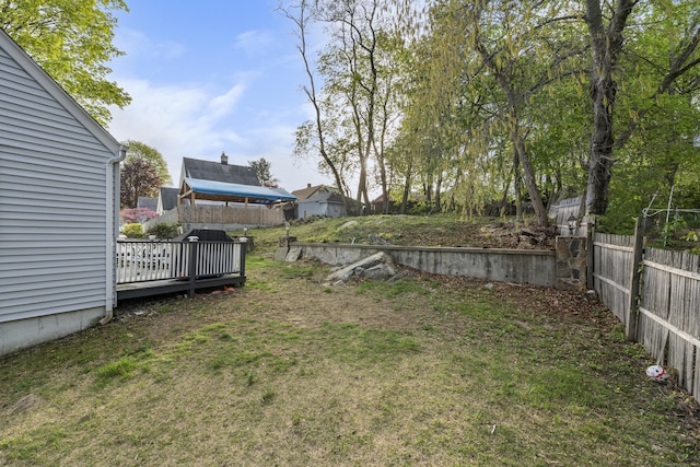 view of yard featuring a deck and fence
