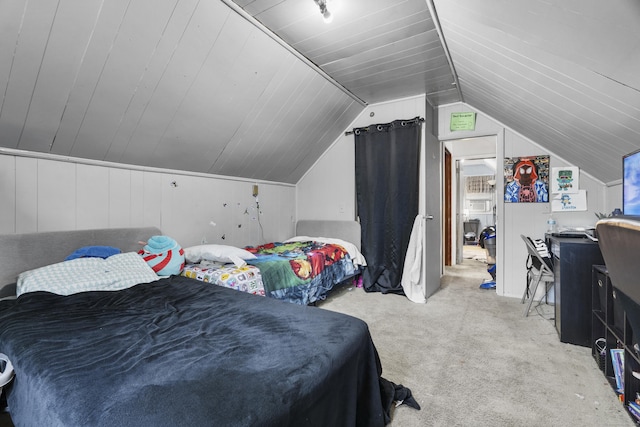 carpeted bedroom with vaulted ceiling
