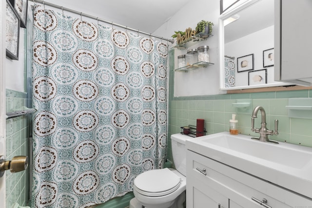 full bath with vanity, curtained shower, toilet, and tile walls