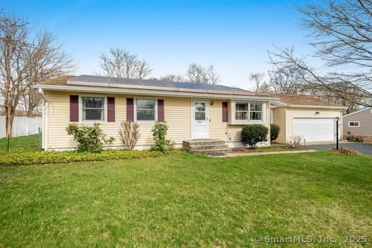 127 Pleasant View Rd, Derby, CT 06418 - ranch-style home featuring fence, solar panels, an attached garage, driveway, and a front yard