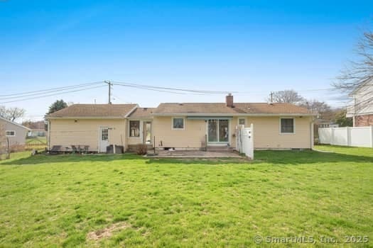 127 Pleasant View Rd, Derby, CT 06418 - rear view of house with fence, a patio area, a lawn, and a chimney