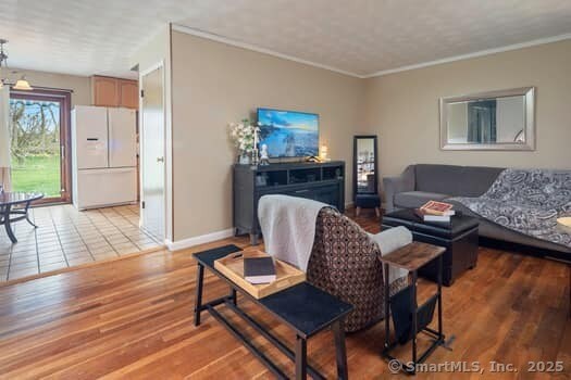 127 Pleasant View Rd, Derby, CT 06418 - living room with crown molding, light wood finished floors, and baseboards