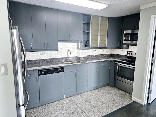 184 Pequot Ave Unit 406, New London, CT 06320 - kitchen with dark stone counters, a sink, decorative backsplash, stainless steel appliances, and gray cabinetry