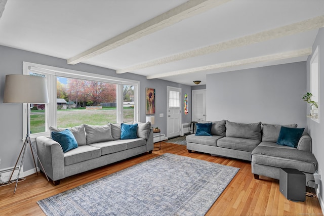 living room featuring beam ceiling, a baseboard radiator, wood finished floors, and plenty of natural light