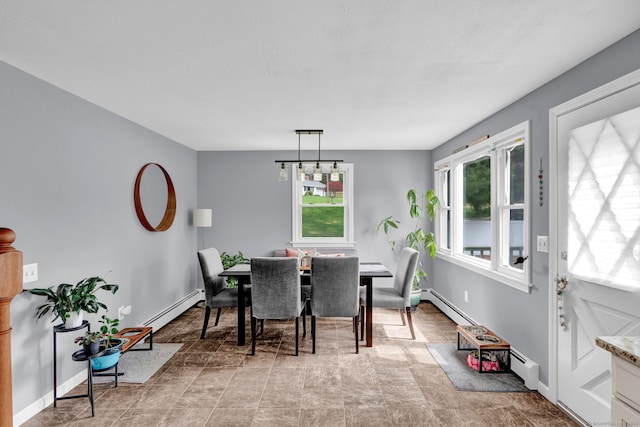 dining space with baseboards and a baseboard radiator