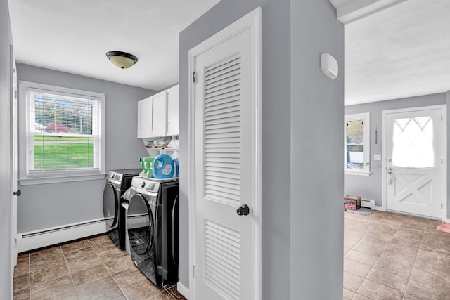 washroom featuring baseboards, cabinet space, washer and clothes dryer, and a baseboard radiator