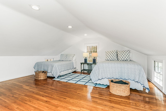 bedroom with recessed lighting, vaulted ceiling, wood finished floors, and baseboards