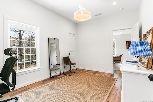 home office with light wood finished floors, baseboards, visible vents, and recessed lighting