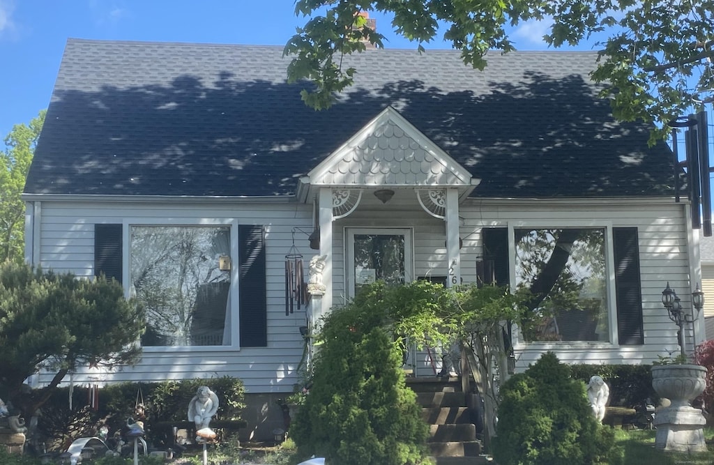 view of front of home featuring roof with shingles