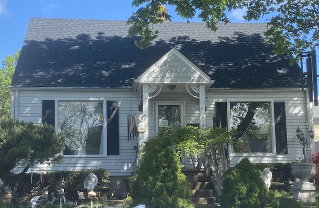 view of front of home featuring roof with shingles