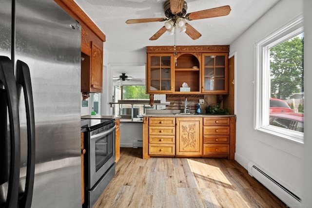 260 Robin St, Bridgeport, CT 06606 - kitchen featuring freestanding refrigerator, a baseboard radiator, electric range, a sink, and light wood-style flooring