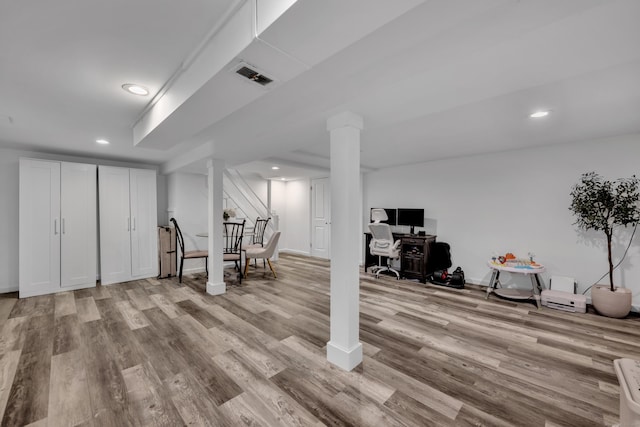 finished below grade area featuring light wood-style floors, baseboards, recessed lighting, and visible vents