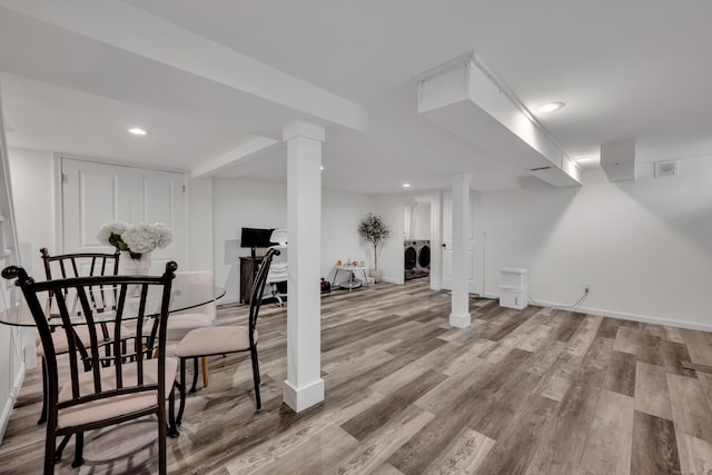 finished basement featuring recessed lighting, baseboards, visible vents, and wood finished floors