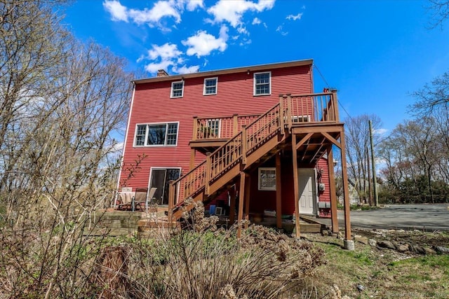 19 Fairchild Rd, Newtown, CT 06470 - rear view of house with a wooden deck, a chimney, and stairs