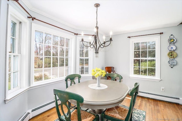 19 Fairchild Rd, Newtown, CT 06470 - dining space featuring a baseboard heating unit, wood finished floors, an inviting chandelier, and crown molding