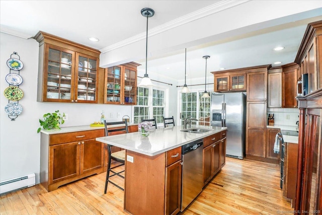 19 Fairchild Rd, Newtown, CT 06470 - kitchen with stainless steel appliances, ornamental molding, a sink, light wood-style floors, and a baseboard radiator