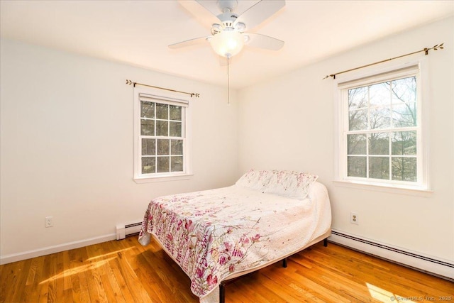 19 Fairchild Rd, Newtown, CT 06470 - bedroom featuring a baseboard radiator, multiple windows, and wood finished floors