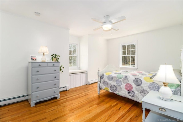19 Fairchild Rd, Newtown, CT 06470 - bedroom featuring a baseboard heating unit, a baseboard radiator, light wood-type flooring, and multiple windows